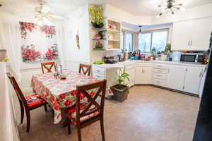 Dining room with a chandelier and a ceiling fan