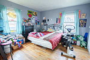 Bedroom with wood-type flooring