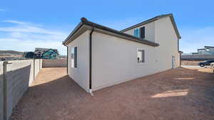 View of home's exterior with a fenced backyard and stucco siding