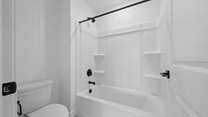 Full bathroom featuring toilet and bathing tub / shower combination