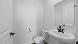 Bathroom with toilet and baseboards