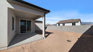 Fenced backyard with a patio area and a mountain view