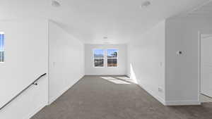 Unfurnished room with dark carpet and a mountain view