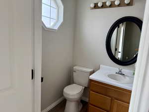 Half bathroom with vanity and dark wood finished floors
