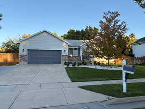View of front of property with concrete driveway, brick siding, and a garage