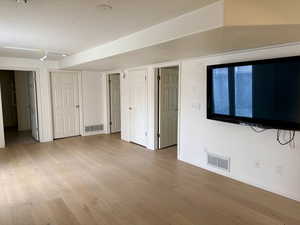 Unfurnished bedroom featuring light wood-style flooring and a textured ceiling