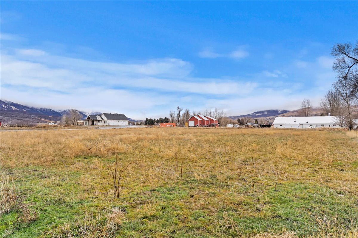 View of yard featuring a view of rural / pastoral area and a mountain view