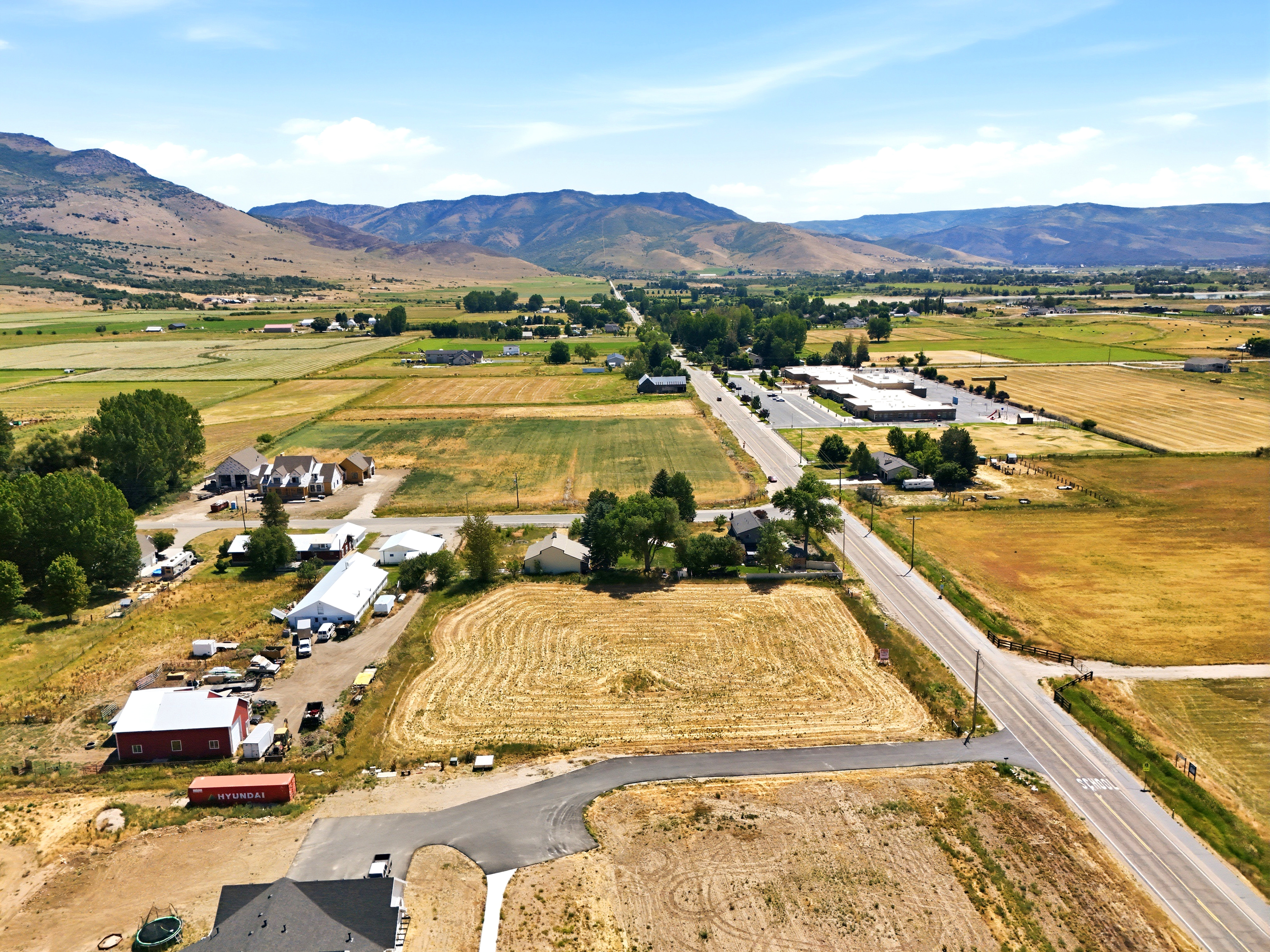 Expansive land parcel featuring open fields and distant mountain scenery