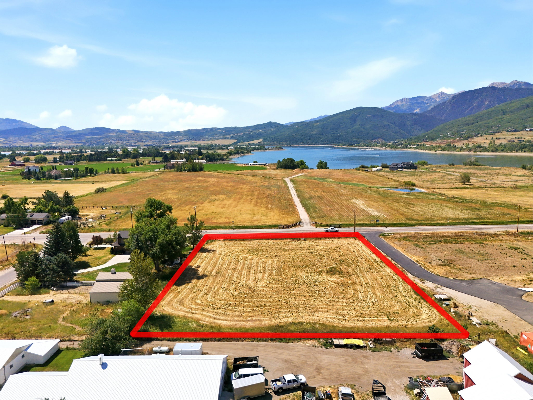 Expansive land parcel featuring direct road frontage and distant mountain and lake scenery