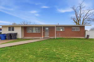 Ranch-style house featuring brick siding and a porch