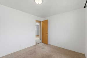 Carpeted spare room with baseboards
