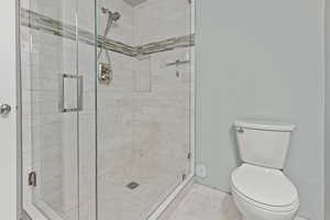 Full bathroom featuring a shower stall