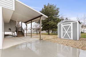 View of patio / terrace featuring a storage shed and stairway