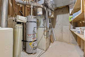 Utility room with strapped water heater and heating unit