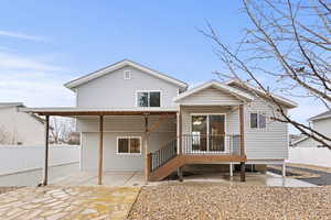Back of house featuring a fenced backyard, a patio area, and a deck