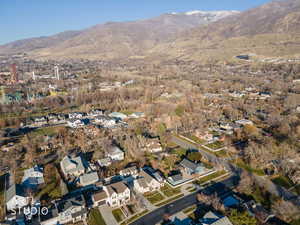 Aerial view of property and surrounding area with nearby suburban area and a mountain backdrop