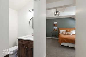 Bedroom featuring lofted ceiling and light colored carpet