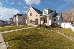 View of front of home featuring a porch, roof with shingles, and brick siding