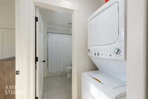 Laundry room with stacked washer and clothes dryer