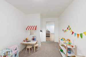 Playroom with light colored carpet and baseboards