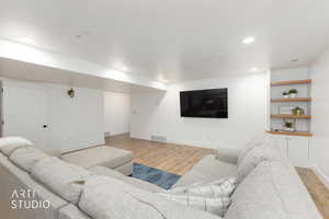 Living area featuring light wood-type flooring and recessed lighting