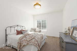 Bedroom featuring light colored carpet and baseboards