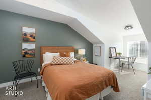 Carpeted bedroom with lofted ceiling and baseboards