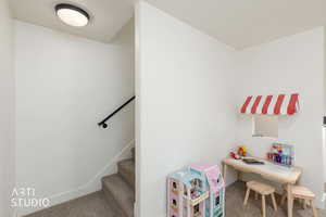 Recreation room featuring carpet floors and baseboards