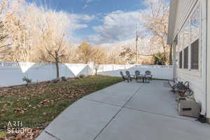 Fenced backyard featuring a patio area and a mountain view