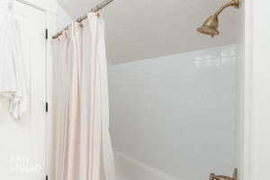 Full bath with shower / tub combo with curtain