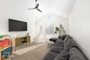 Living room featuring carpet flooring, lofted ceiling, and a ceiling fan