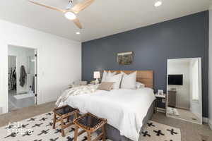Bedroom with carpet flooring, ceiling fan, recessed lighting, and an accent wall