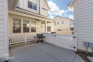 View of patio / terrace featuring a grill and a gate