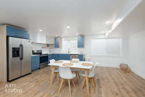 Dining space with light wood-style floors and recessed lighting
