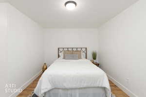 Bedroom featuring wood finished floors and a textured ceiling