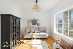 Living area featuring hardwood / wood-style flooring and baseboards