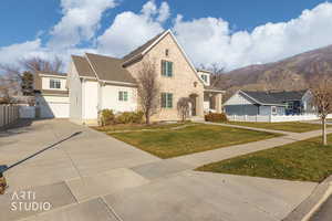 Traditional home with driveway, a garage, a shingled roof, and a mountain view
