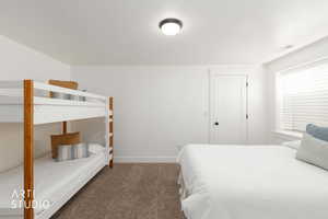 Bedroom with carpet flooring and a textured ceiling
