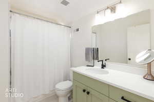 Bathroom featuring vanity and shower / tub combo with curtain