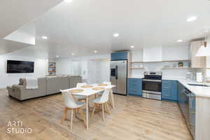 Dining room with light wood-style floors and recessed lighting