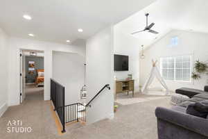 Living room featuring light colored carpet, lofted ceiling, ceiling fan, and recessed lighting