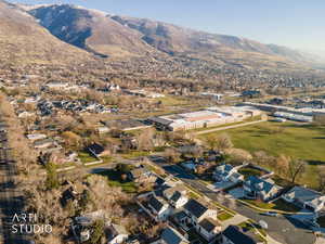 Aerial overview of property's location featuring nearby suburban area and a mountain backdrop