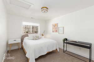 Bedroom featuring attic access and carpet