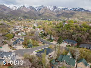 Aerial view of property's location featuring nearby suburban area and a mountainous background