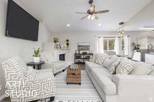 Living area featuring a glass covered fireplace, ceiling fan, and recessed lighting
