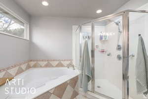 Bathroom with a garden tub, a stall shower, and recessed lighting