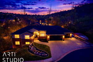 View of front of house featuring a garage, concrete driveway, brick siding, and a front yard