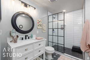 Bathroom with vanity, a walk in shower, and recessed lighting