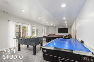 Rec room with light colored carpet and recessed lighting