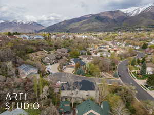 Aerial view of property's location featuring nearby suburban area and a mountain backdrop
